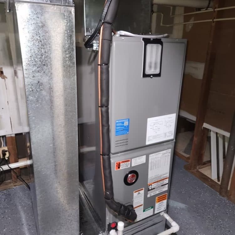 Vertical air handler installed with sealed sheet metal plenum in a basement mechanical area